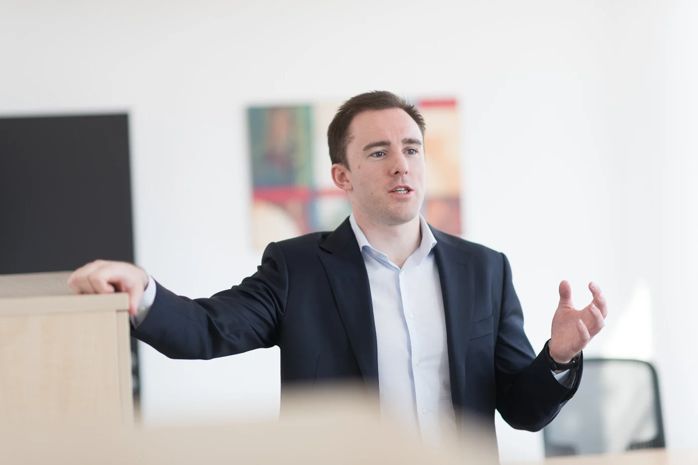 Kieran Moloney discussing business strategy in his office